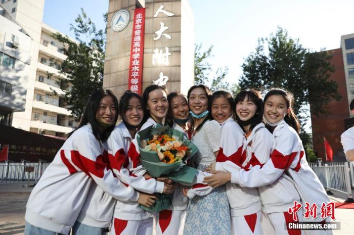 資料圖：6月10日，在北京人大附中高考考點(diǎn)外，考生們相擁拍照留念。當(dāng)日，北京市2021年高考結(jié)束?！?<a target='_blank'  data-cke-saved- ><p  align=